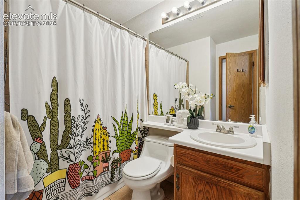 Image 13 of 24: Bathroom featuring a vanity with a white countertop, an undermount sink, an
