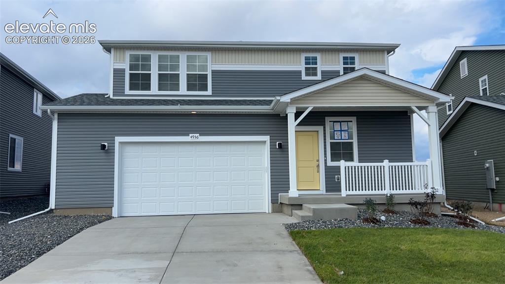 Image 1 of 41: Modern exterior featuring gray siding, white trim, and a prominent white ga