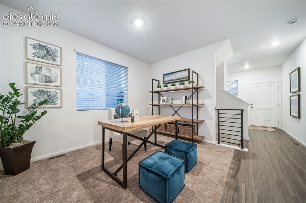 Image 12 of 41: Bright interior with carpeted flooring, featuring a window with blinds, and