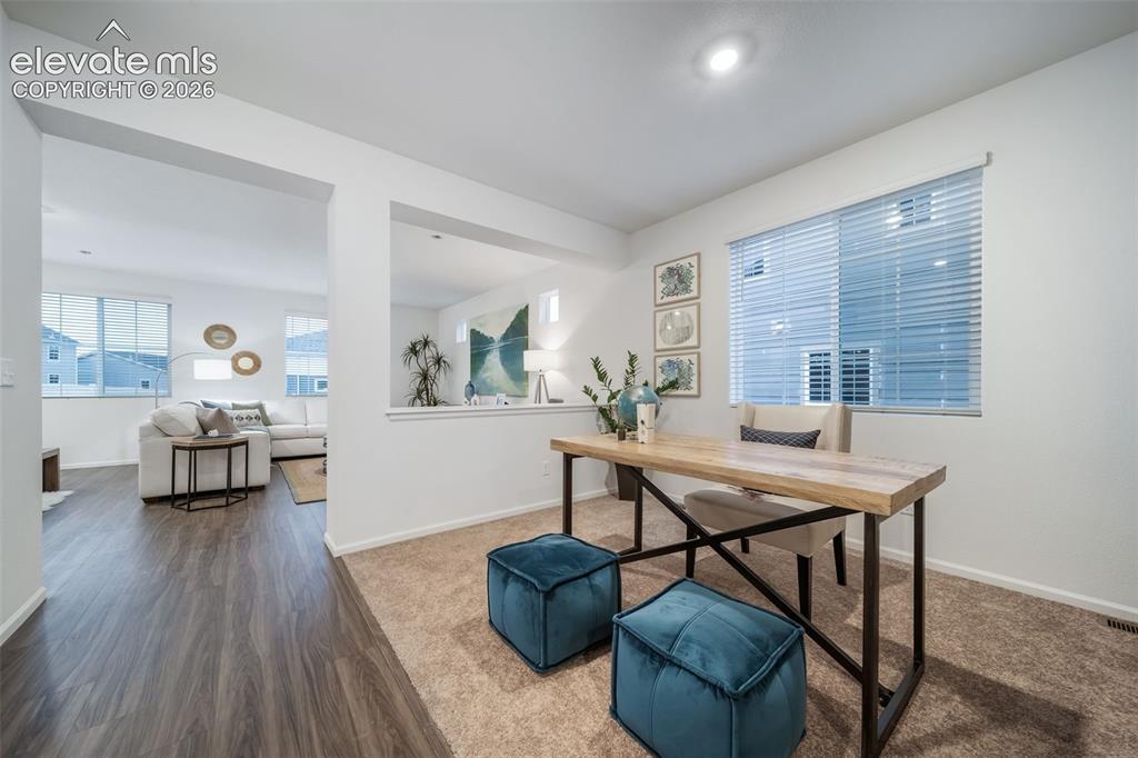 Image 14 of 41: Recessed lighting, wood-finish flooring, white walls, and a large window wi