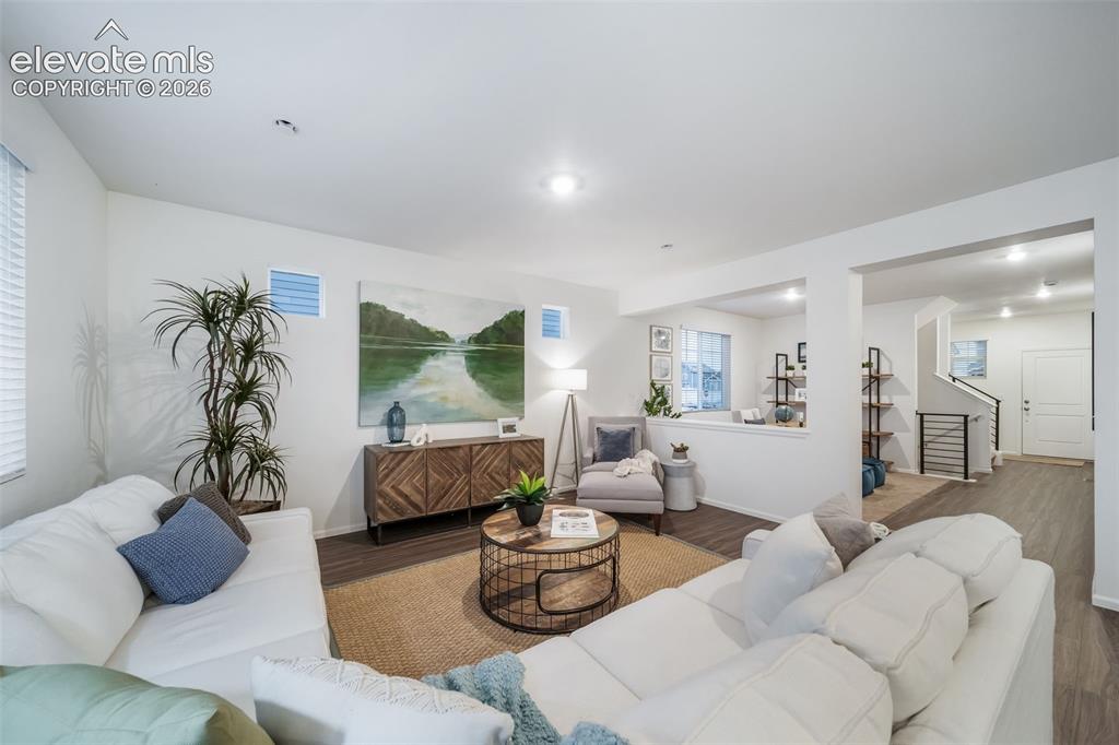 Image 17 of 41: Open-concept living space featuring wood-finish flooring, recessed lighting