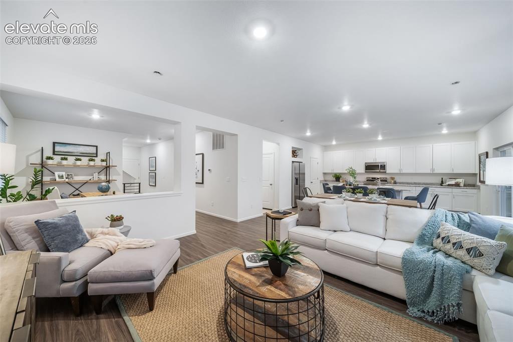 Image 18 of 41: Open-concept living space featuring wood-finish flooring, recessed lighting