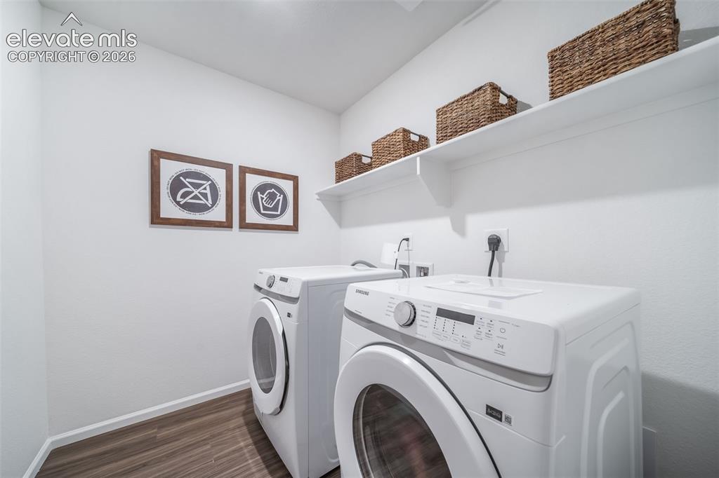 Image 28 of 41: Dedicated laundry area featuring a front-loading washing machine, a front-l