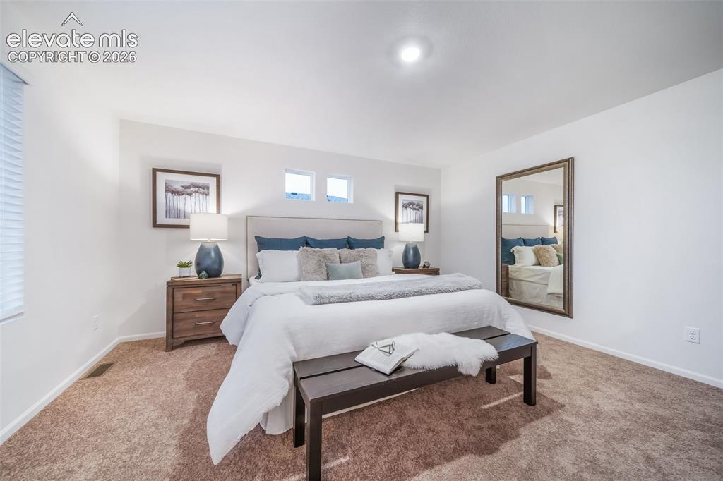 Image 35 of 41: Recessed lighting illuminates a spacious room featuring wall-to-wall carpet