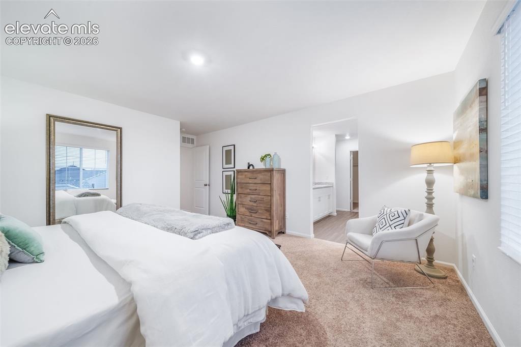 Image 36 of 41: Recessed ceiling lighting, white walls, carpeted flooring, and an open door