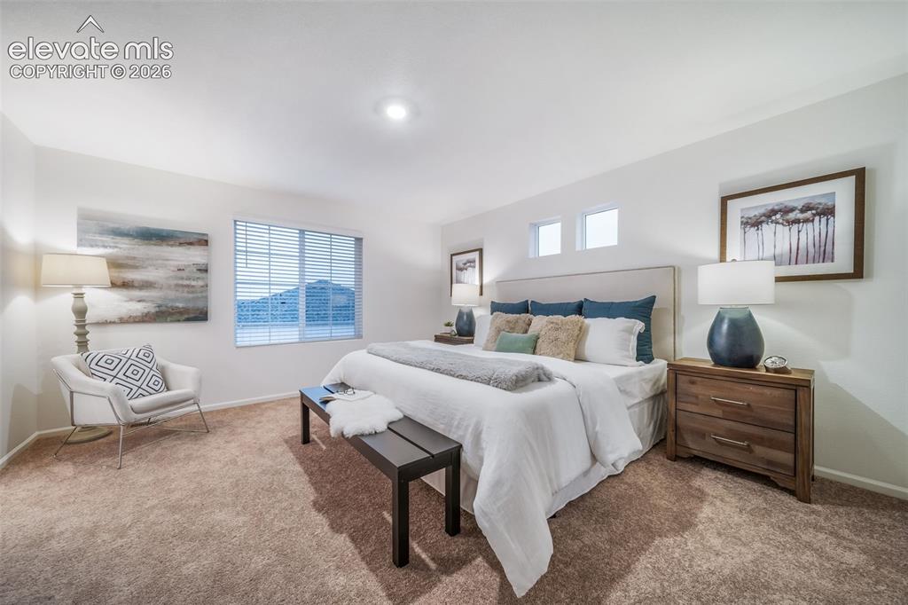 Image 37 of 41: Plush carpeting, recessed lighting, and a large window with blinds
*photos