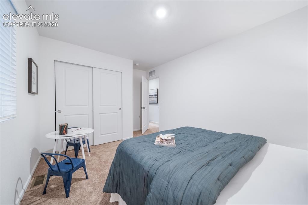 Image 4 of 41: Plush carpet flooring with neutral wall paint, overhead lighting, and white