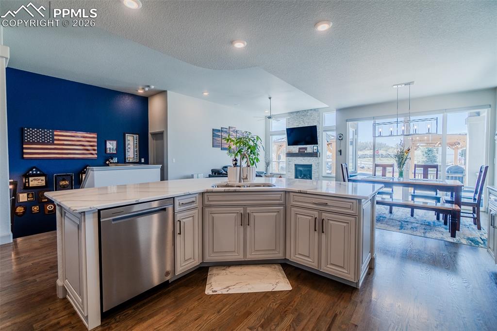 Image 11 of 49: Open-concept kitchen featuring a multi-level island with integrated stainle