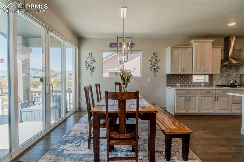 Image 17 of 49: Open-concept living area featuring wood-finish flooring, a contemporary kit