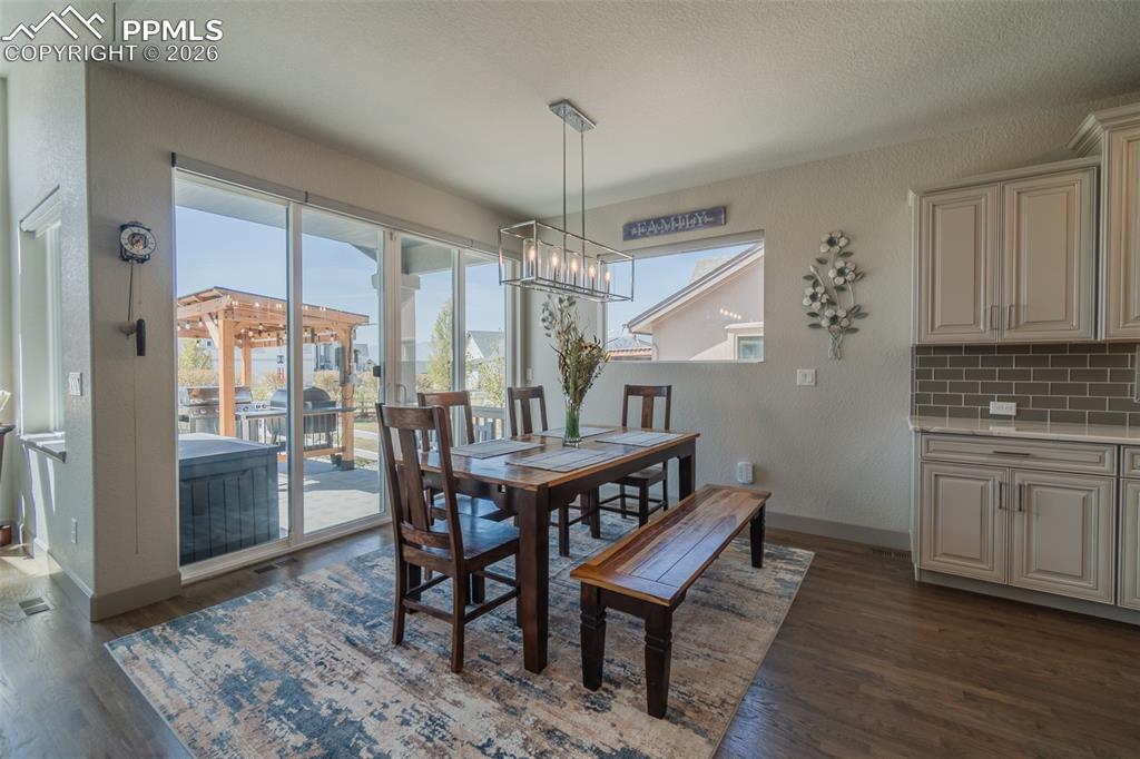 Image 18 of 49: Sliding glass doors provide access to an outdoor patio featuring a wooden p