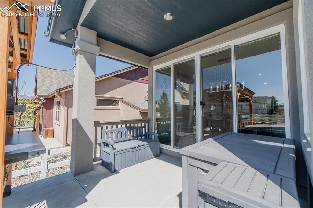 Image 20 of 49: Expansive concrete patio with a covered ceiling, providing an outdoor livin