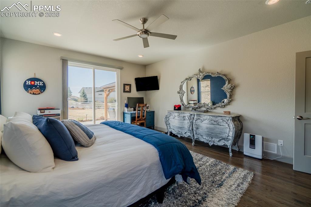 Image 28 of 49: Spacious room featuring wood-finish flooring, recessed ceiling lighting, an