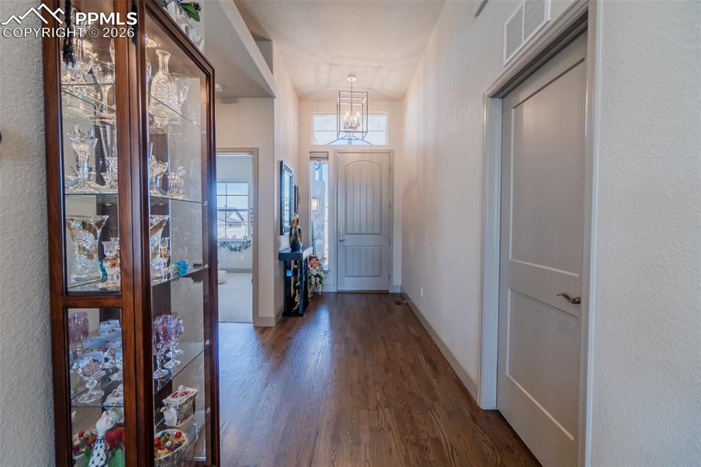 Image 32 of 49: Welcoming entry hall featuring wood-finish flooring, a contemporary light f