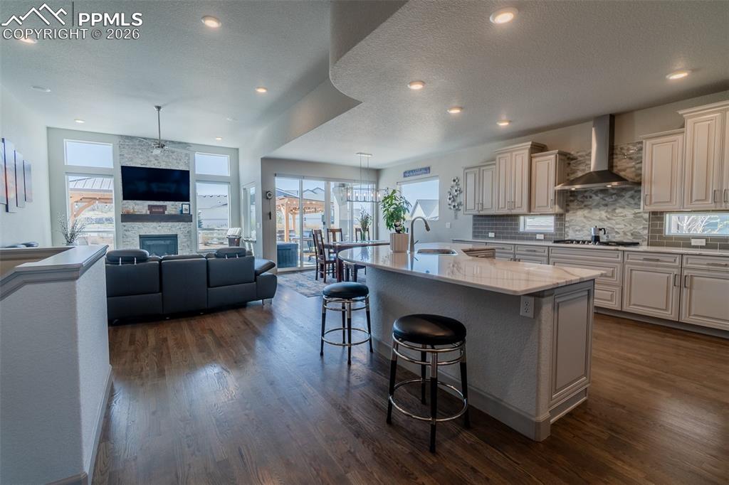 Image 4 of 49: Expansive open-concept living space featuring wood-finish flooring
