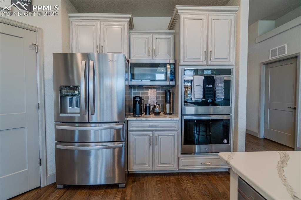 Image 6 of 49: Stainless steel French door refrigerator, built-in microwave, and double ov