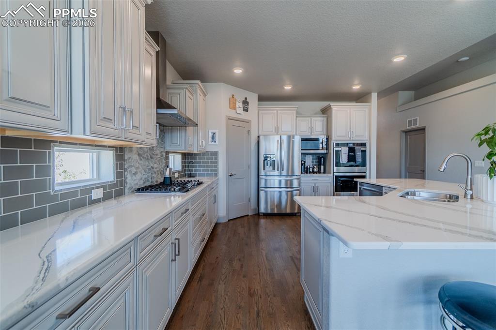 Image 9 of 49: Kitchen featuring wood-finish flooring, light grey cabinetry, white counter