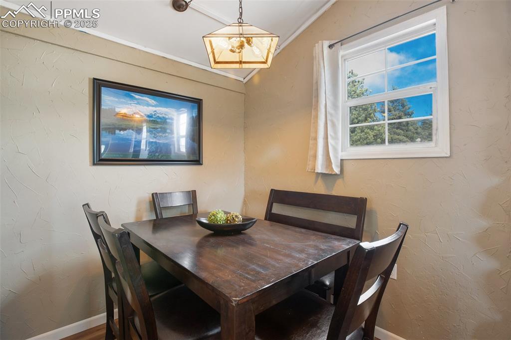 Image 16 of 36: Dining space with a textured wall and ornamental molding