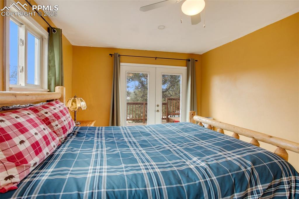 Image 26 of 36: Bedroom featuring access to outside, a ceiling fan, and french doors