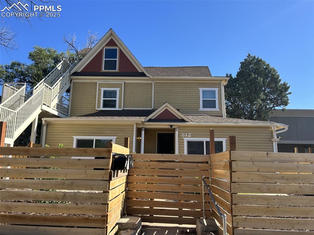 Caption: View of front of home with roof with shingles