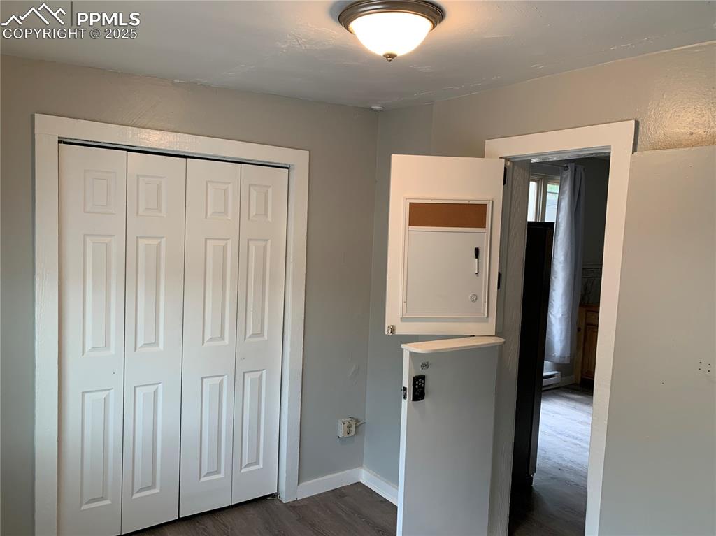 Image 13 of 49: Unfurnished bedroom with dark wood finished floors and a closet