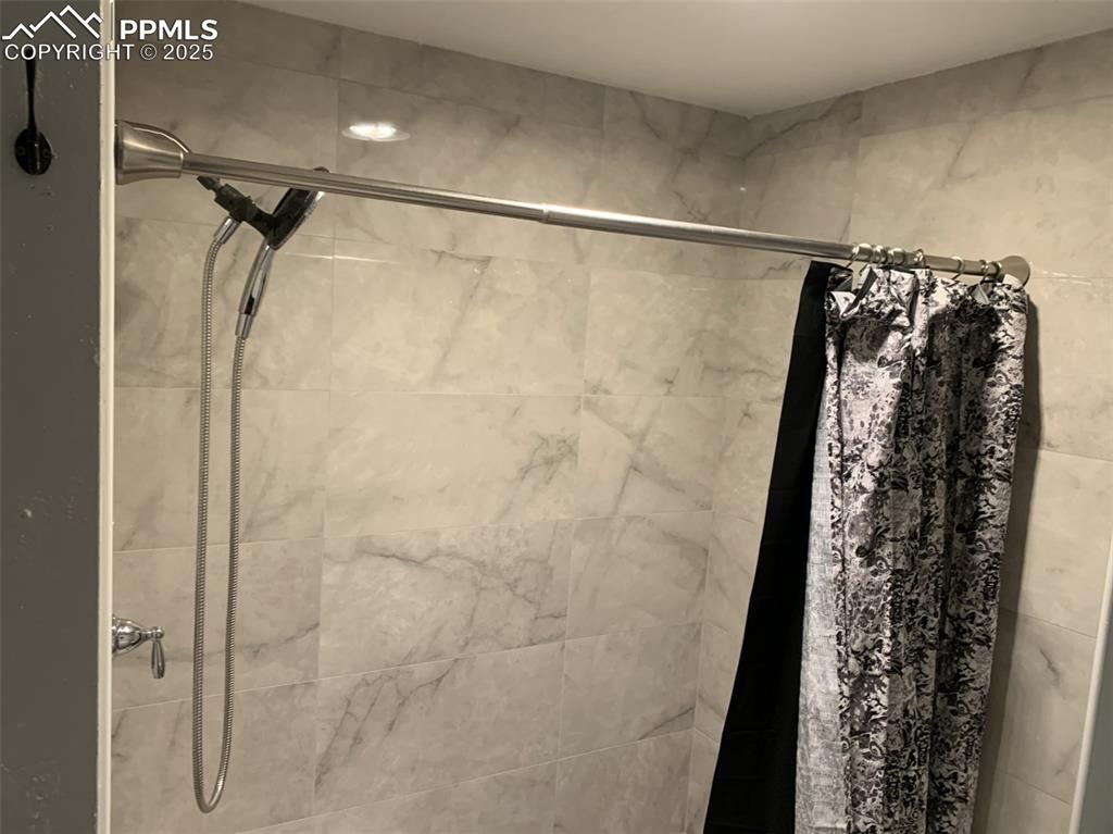 Image 15 of 49: Full bathroom featuring tiled shower
