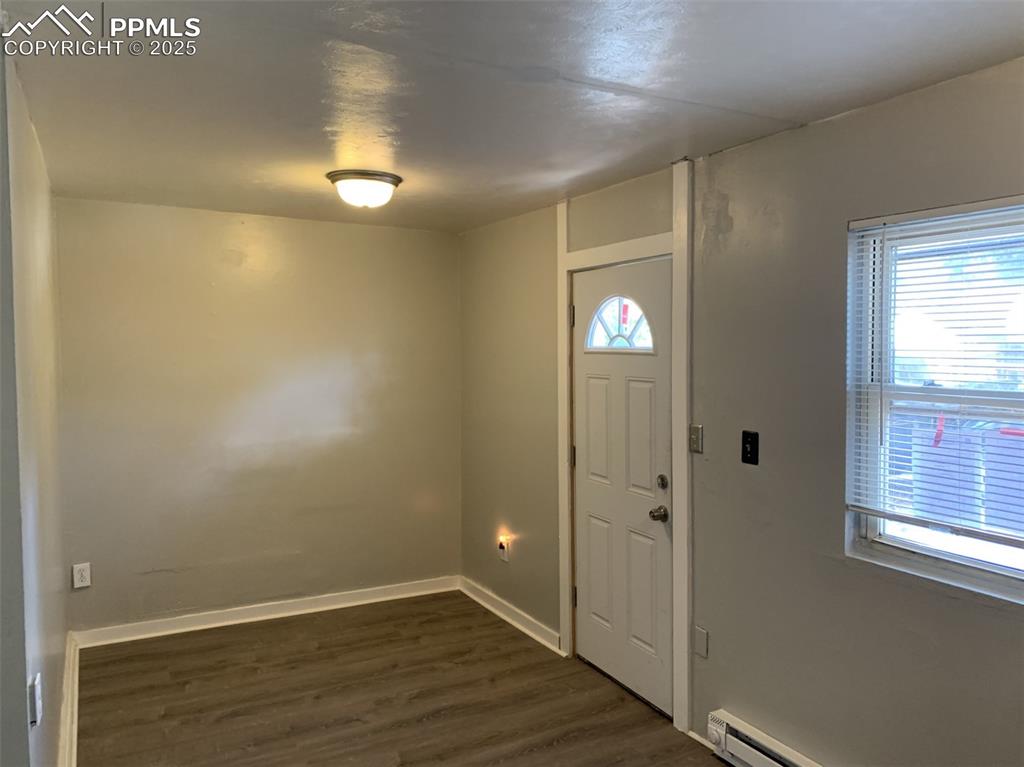 Image 16 of 49: APT 2 Foyer entrance with dark wood-style flooring, healthy amount of natur