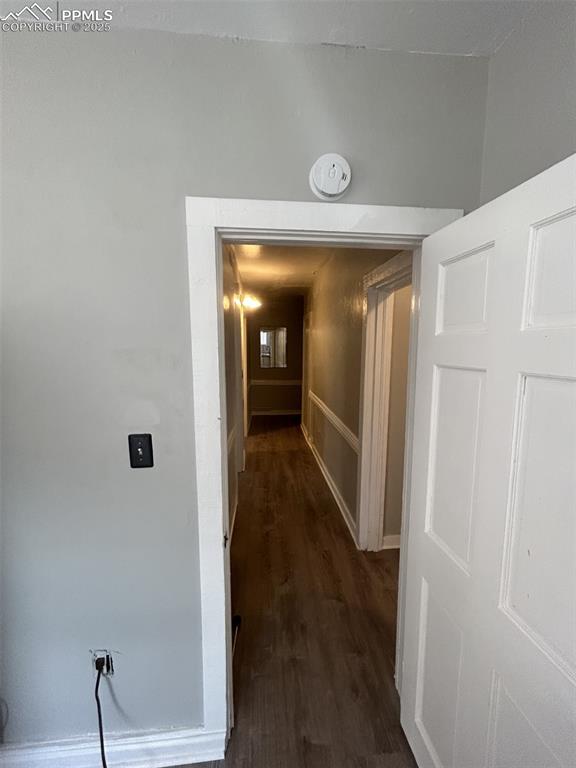 Image 33 of 49: Hall featuring dark wood-type flooring and baseboards