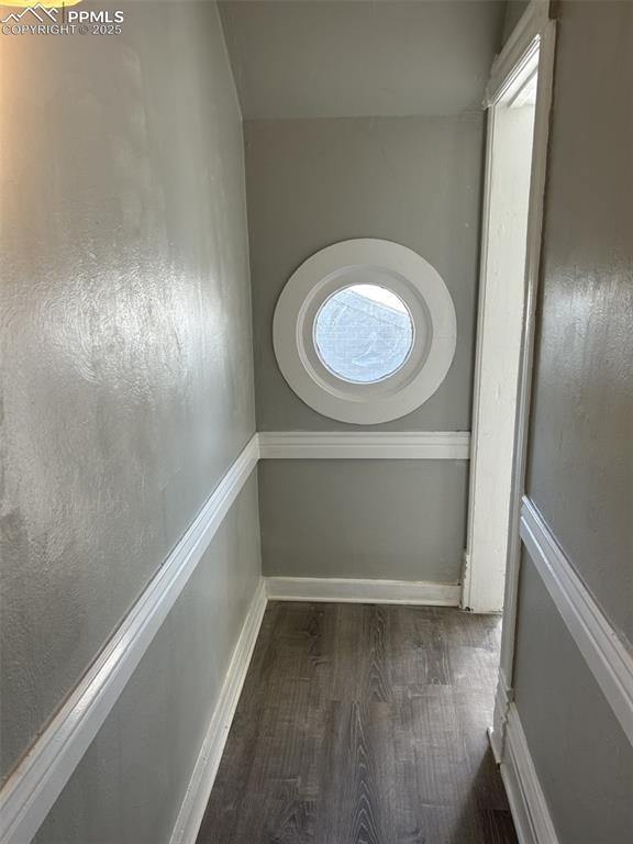 Image 35 of 49: Spare room with wood finished floors and baseboards