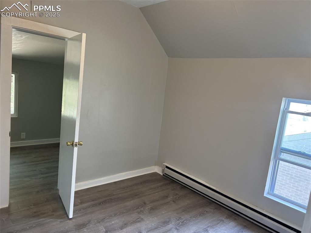 Image 48 of 49: Additional living space featuring plenty of natural light, a baseboard heat