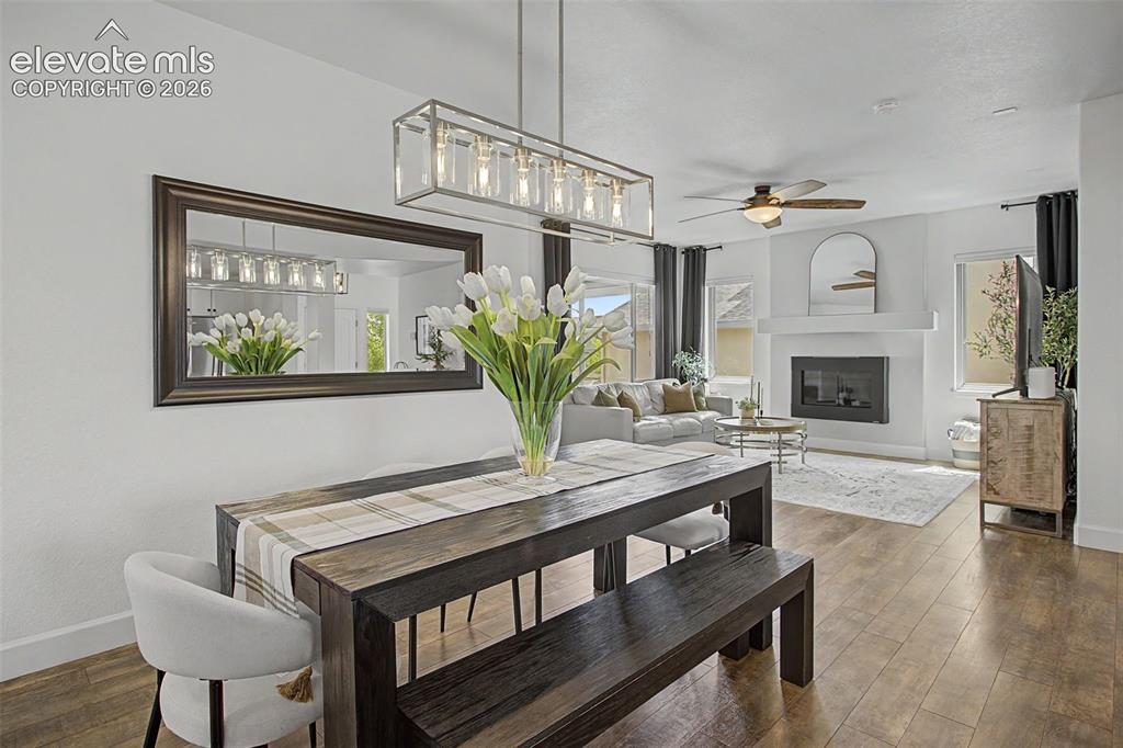 Image 13 of 35: Open-concept dining and living areas featuring LVP-finish flooring