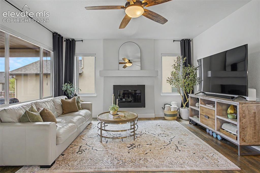 Image 14 of 35: Spacious living area featuring a built-in fireplace with a mantel, LVP fini