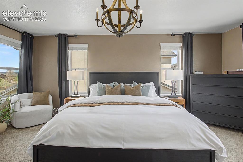 Image 18 of 35: Carpeted interior space featuring, Four windows, and a ceiling-mounted chan