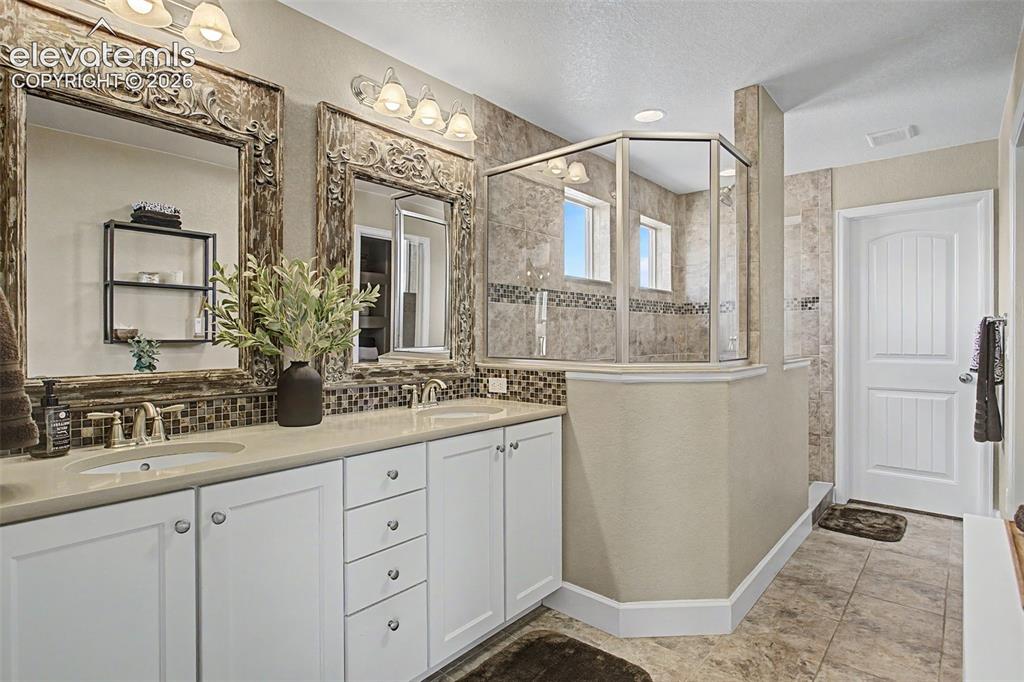 Image 21 of 35: Double vanity with white cabinetry 