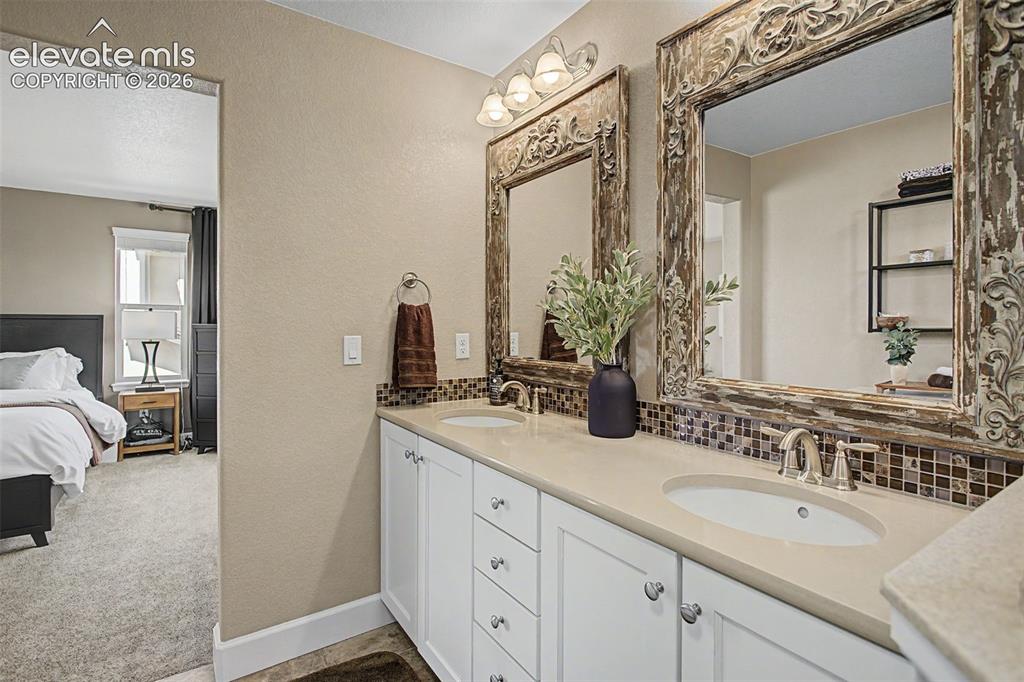 Image 23 of 35: Dual vanity with white cabinetry