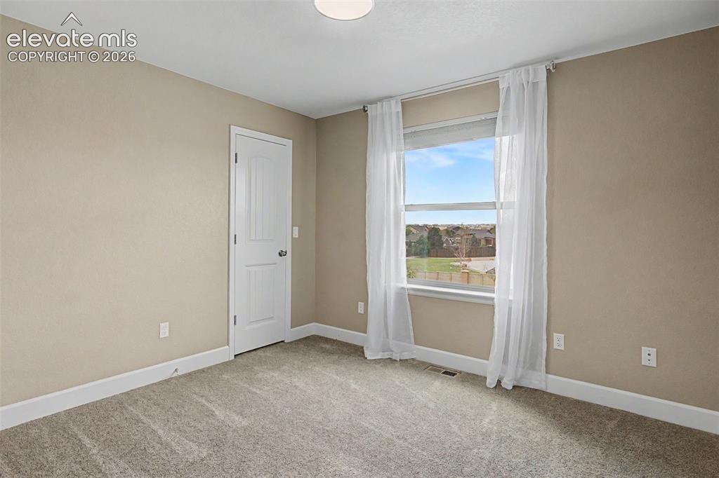 Image 26 of 35: Carpeted room featuring a single window with white trim, a recessed light f