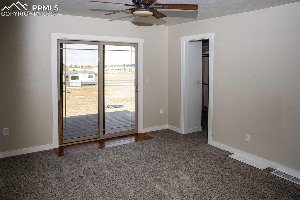 Image 10 of 23: Main level primary bedroom with walkout