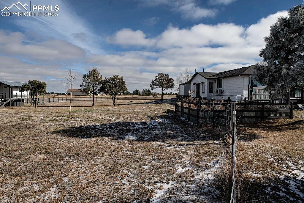 Image 18 of 23: Back yard with playhouse