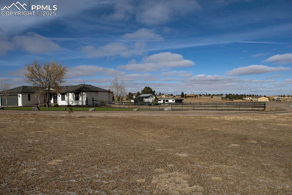 Image 20 of 23: Property View of fenced yard, playhouse and detached garage.