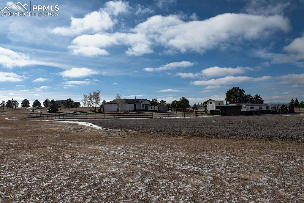 Image 24 of 29: Property view from backyard