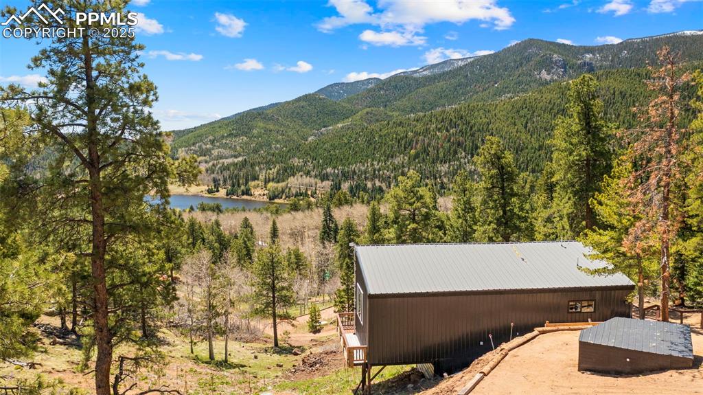 Image 15 of 35: View of mountain background featuring a heavily wooded area and San Isabel 