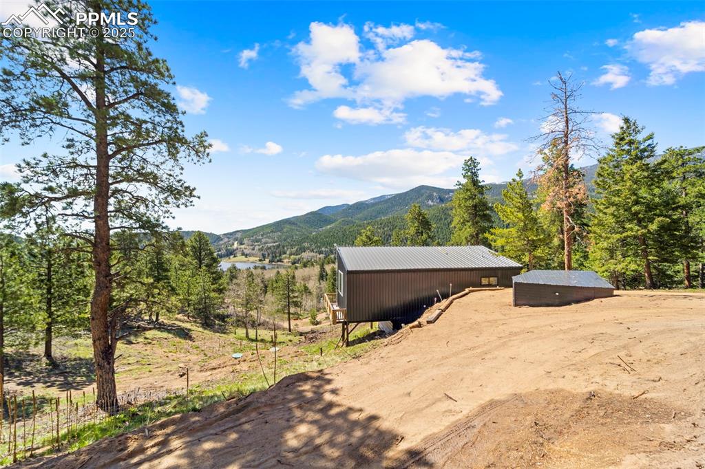 Image 16 of 35: View of mountain background with a forest