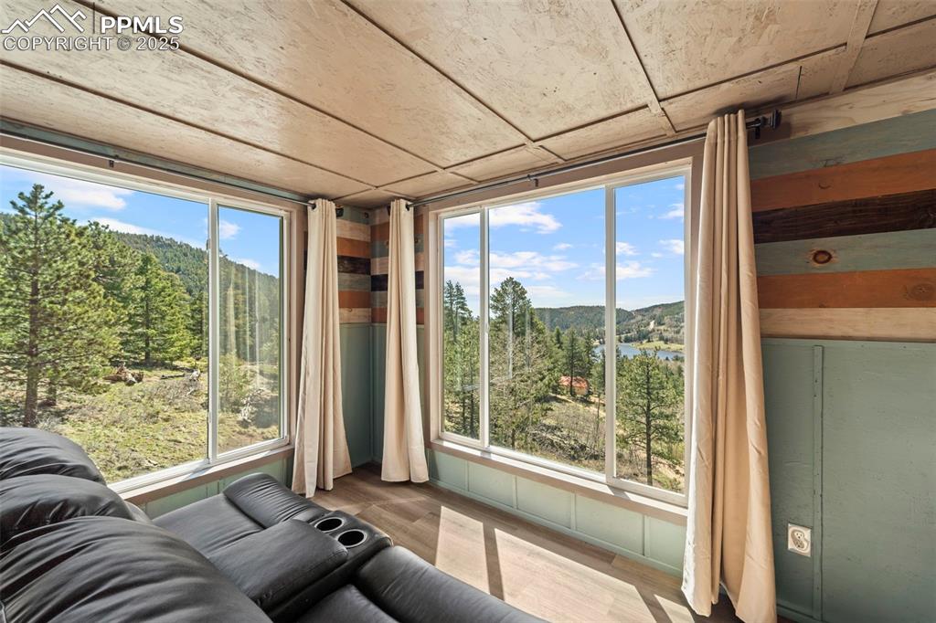 Image 27 of 35: Sunroom featuring a mountain view and a view of trees