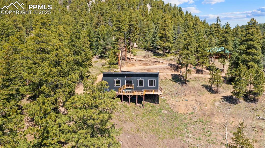 Image 8 of 35: View from above of property with a forest