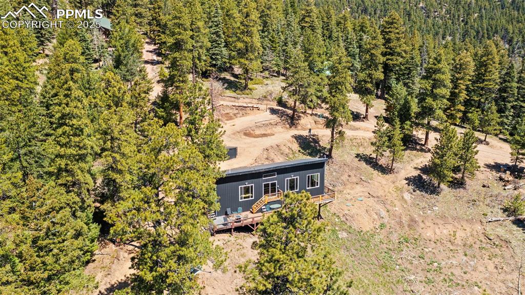Image 9 of 35: Aerial view of property and surrounding area featuring a forest
