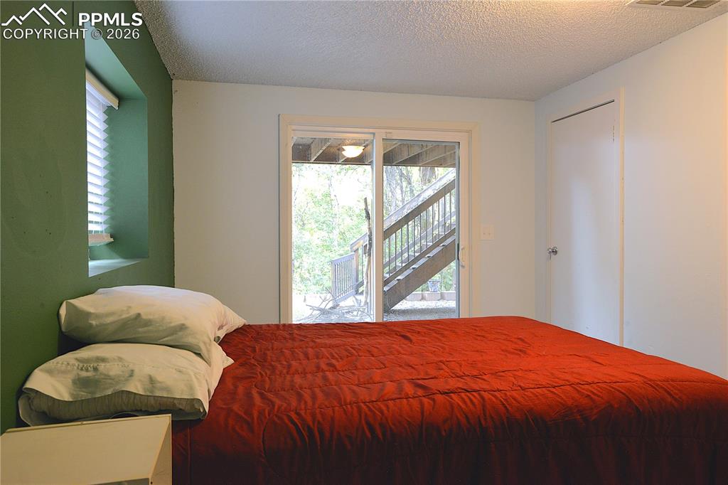 Image 21 of 25: Lower level bedroom has access to rear yard.