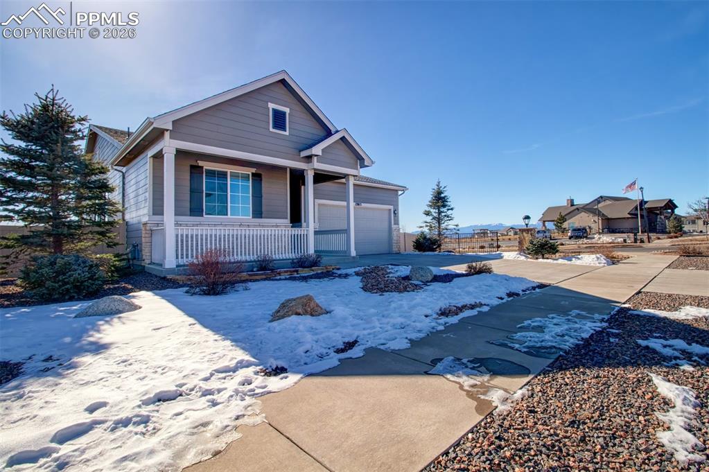 Image 3 of 29: Covered front porch and steps away from the Community Center