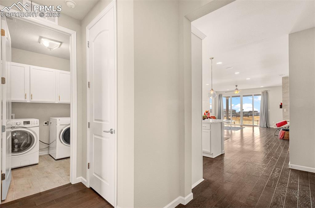 Image 4 of 29: Enter the home and notice the laundry room and front bedroom to the left