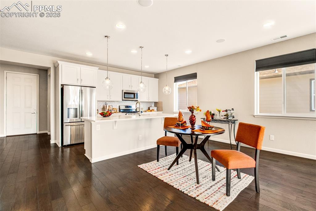 Image 7 of 29: Quartz countertops with an island and breakfast bar