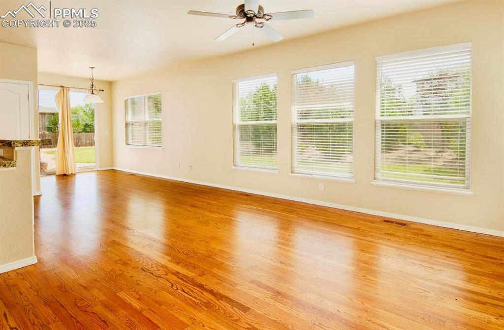 Image 20 of 42: Unfurnished living room with plenty of natural light, light wood finished f
