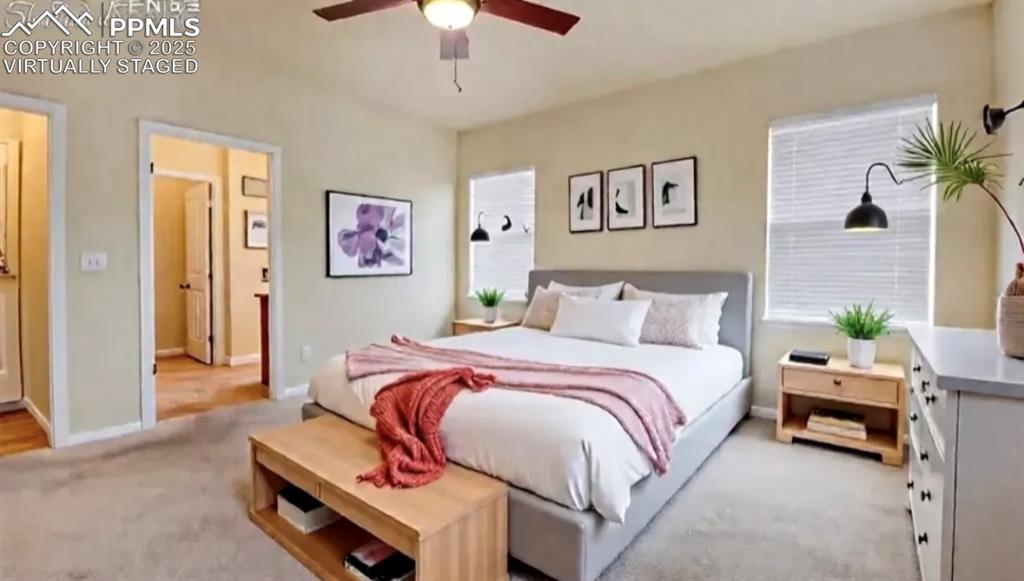 Image 21 of 42: Virtually Staged Primary bedroom on main level 